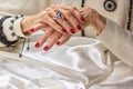Red manicure on old womans hands. Royalty Free Stock Photo