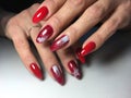 red manicure with white snowflakes on long nails