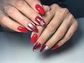 red manicure with white snowflakes on long nails