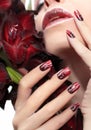 Red manicure with white wavy lines.