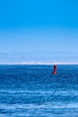 A red marker buoy floating in the ocean. Royalty Free Stock Photo