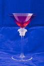 Red martini glass with a detailed glass sculpture Royalty Free Stock Photo