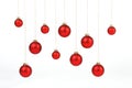 Red matt christmas balls hanging on golden strings on white background