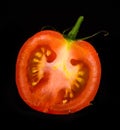 Red mature tomato isolated on a black background Royalty Free Stock Photo