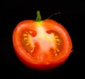 Red mature tomato isolated on a black background Royalty Free Stock Photo