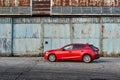 A red Mazda 3 parked in front of an old airplane hangar. Mazda 3. Katowice- Poland, February 15, 2015