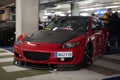 Red Mazda RX8 with black hood and lip modified for illegal racing