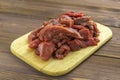 Meat beef cut into pieces lies on a wooden Board