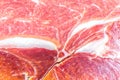 Red meat texture close up photo. Italian prosciutto crudo or jamon. Raw ham. Pork meat background