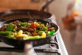 Red meat with vegetables in old fry pan on a cooker. Royalty Free Stock Photo