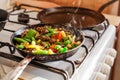 Red meat with vegetables in old fry pan on a cooker. Royalty Free Stock Photo
