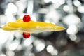 Red medical capsule on yellow ointment among bokeh