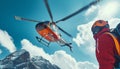 Red Medical Rescue helicopter landing in high altitude Himalayas mountains. High Himalayas expedition during mount climbing. Royalty Free Stock Photo