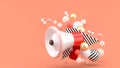 Red megaphone among colorful balls on pink background. Royalty Free Stock Photo