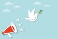 Red megaphone with paper white dove or pigeon carrying olive branch flying in cloudy sky background, Concept for World Peace Day. Royalty Free Stock Photo