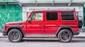 red Mercedes-AMG G 63 (W463) second generation, side view. Test Drive in city