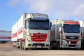 Red Mercedes-Benz Actros and MAN 2551 Trucks on a Yard