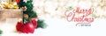 Red Merry Christmas and happy new year handwriting with xmas tree and gift box at blur bokeh light background,Winter holiday Royalty Free Stock Photo