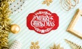 REd Merry christmas lable background.top view of sparkling gold tinsel,ball,ornament decorate on green strip line table.holiday