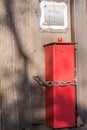 Red metal ashtray outdoors