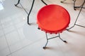 Red metal chair with black metal structure legs on granite tiles Royalty Free Stock Photo