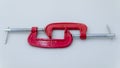 red metal clamp, press for locksmith work.red G-clamps Royalty Free Stock Photo