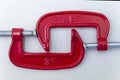 red metal clamp, press for locksmith work.red G-clamps Royalty Free Stock Photo