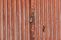 Red metal door closed on the lock corrugated steel fence gate padlock garage shed in Sofia, Bulgaria, Eastern Europe Royalty Free Stock Photo