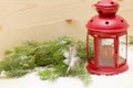 Red metal lantern has a burning candle. Royalty Free Stock Photo