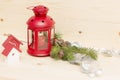 Red metal lantern has a burning candle. Royalty Free Stock Photo