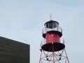Red metal lighthouse in the harbor of Den Helder Netherlands Royalty Free Stock Photo