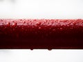 Red metal pipe in the rain Royalty Free Stock Photo