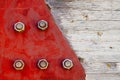 Red metal plate fixed with large bolt screws to a junction in wooden pillar girder used in house roofing