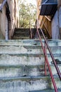 Red Metal Railing Up Old Concrete Steps Royalty Free Stock Photo