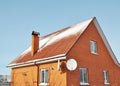 Red metal roof tile and chimney covered with snow Royalty Free Stock Photo