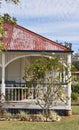 Verandah on old Queenslander with faded red metal roof