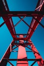 Red metal structure with blue sky in the background. Generative AI Royalty Free Stock Photo