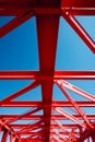 Red metal structure with blue sky in the background. Generative AI Royalty Free Stock Photo