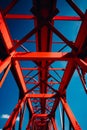 Red metal structure with blue sky in the background. Generative AI Royalty Free Stock Photo