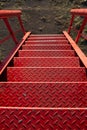 Red metal textured staircase going down