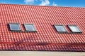 Red Metal tiled Roof with New Dormers, Roof Windows, Skylights and Roof Protection from Snow Board Royalty Free Stock Photo