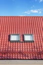 Red Metal tiled Roof with New Dormers, Roof Windows, Skylights and Roof Protection from Snow BoardÃÅ½ Royalty Free Stock Photo