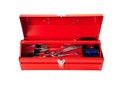 Red metal tool box with tools on white