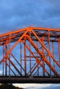 Red metallic bridge. Blue sky with clouds background. Royalty Free Stock Photo