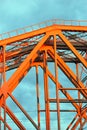 Red metallic bridge. Blue sky with clouds background. Royalty Free Stock Photo