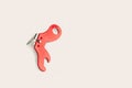 Red metallic can opener on a white background with copy space Royalty Free Stock Photo