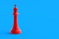 Red metallic chess figure king on blue background. Table games