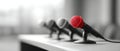 Close-up of a red microphone in focus with three blurred black microphones on a table in a conference or press room setting Royalty Free Stock Photo