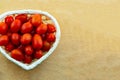 Red mini tomato vegetables many fruits in a basket heart shape copy space culinary design Royalty Free Stock Photo