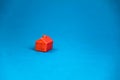 red miniature lonely house standing on a blue background Royalty Free Stock Photo